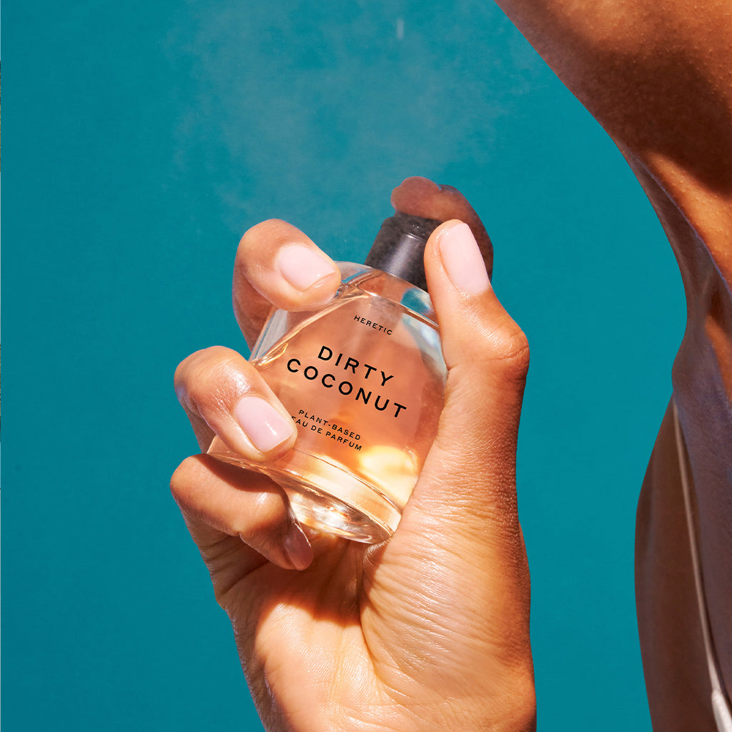 Hand spraying Dirty Coconut perfume