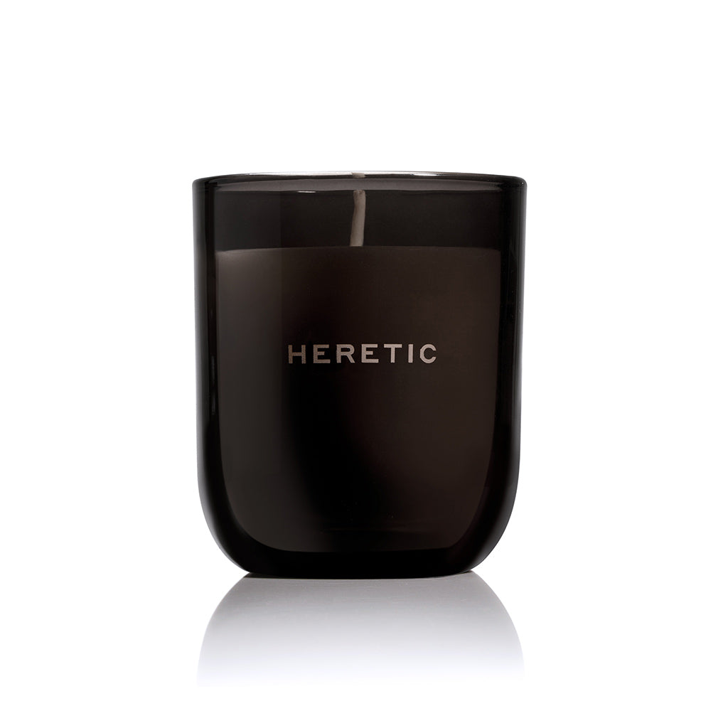 Candle in smoky glass vessel