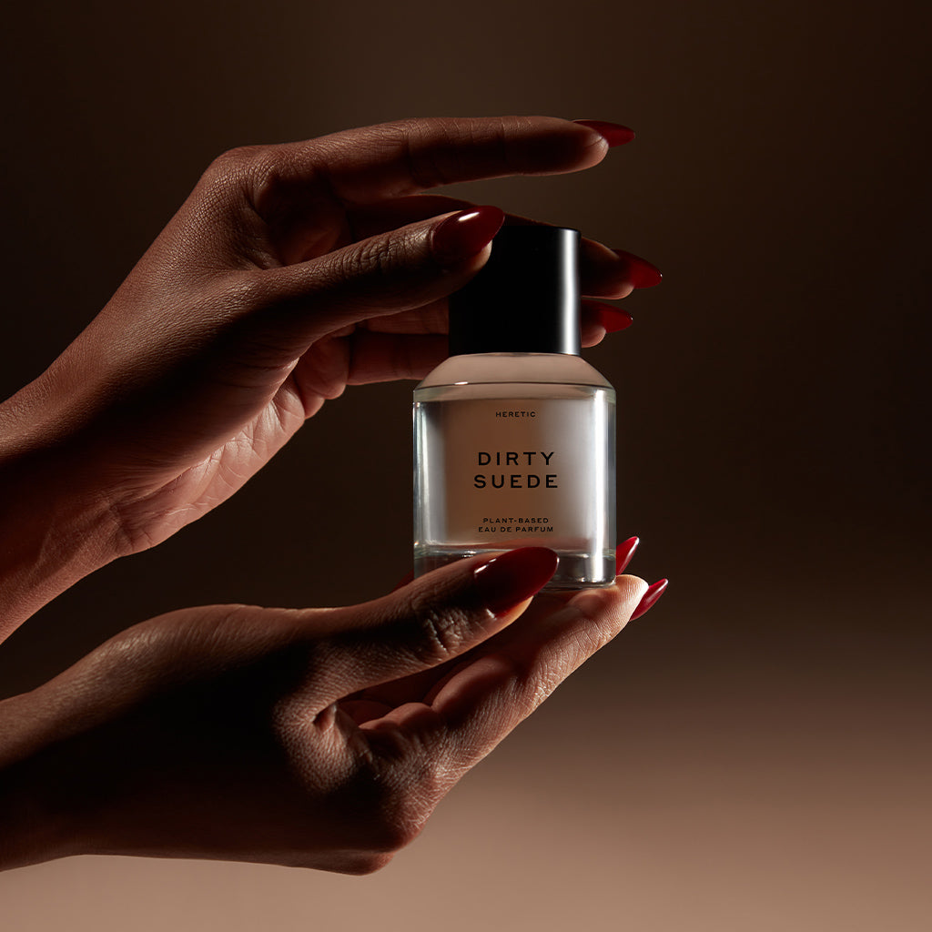 Hands holding Dirty Suede 50ml bottle