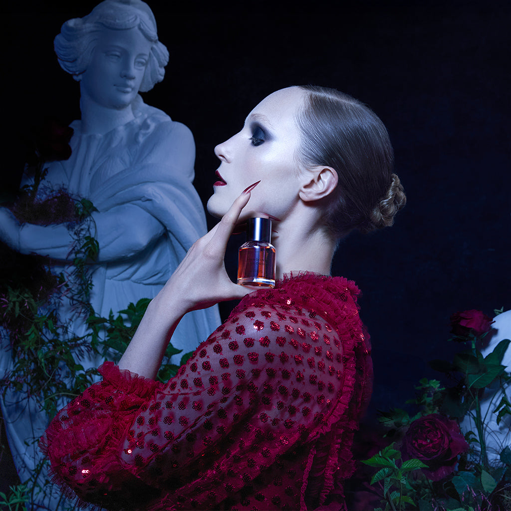 Model holding Dragon's Blood Bottle