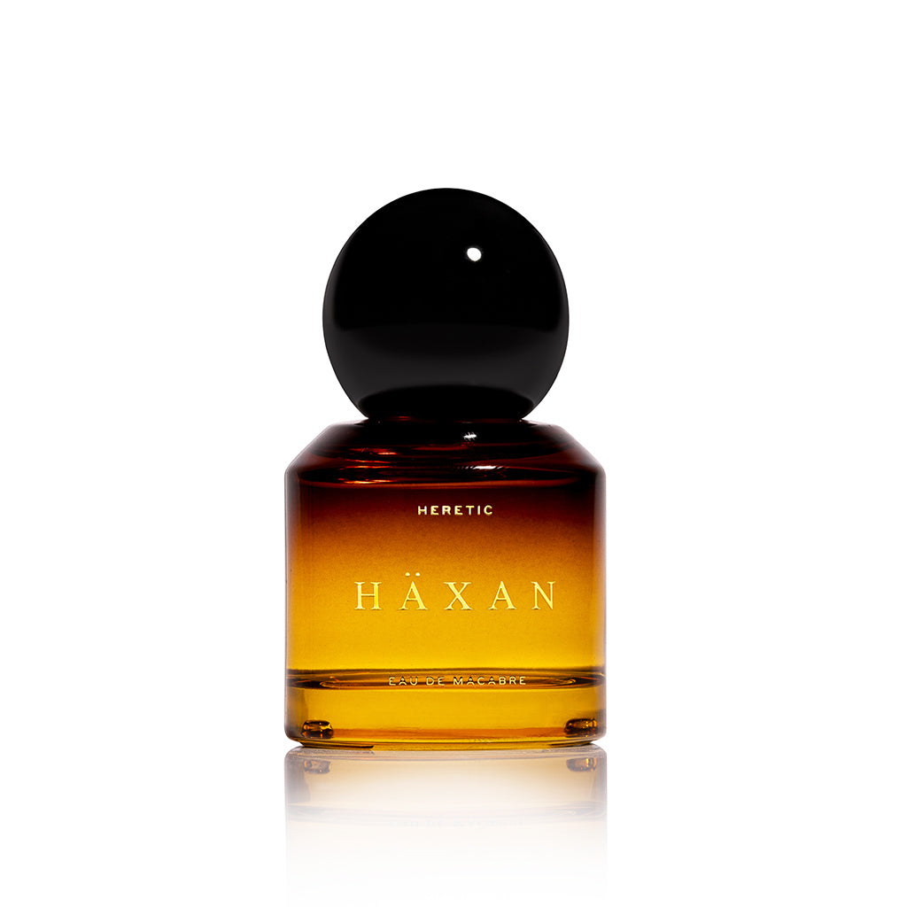 Häxan perfume bottle with black cap on a white background