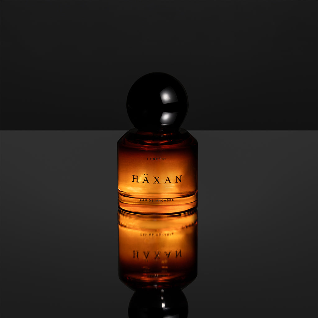 Häxan perfume bottle with a dark background