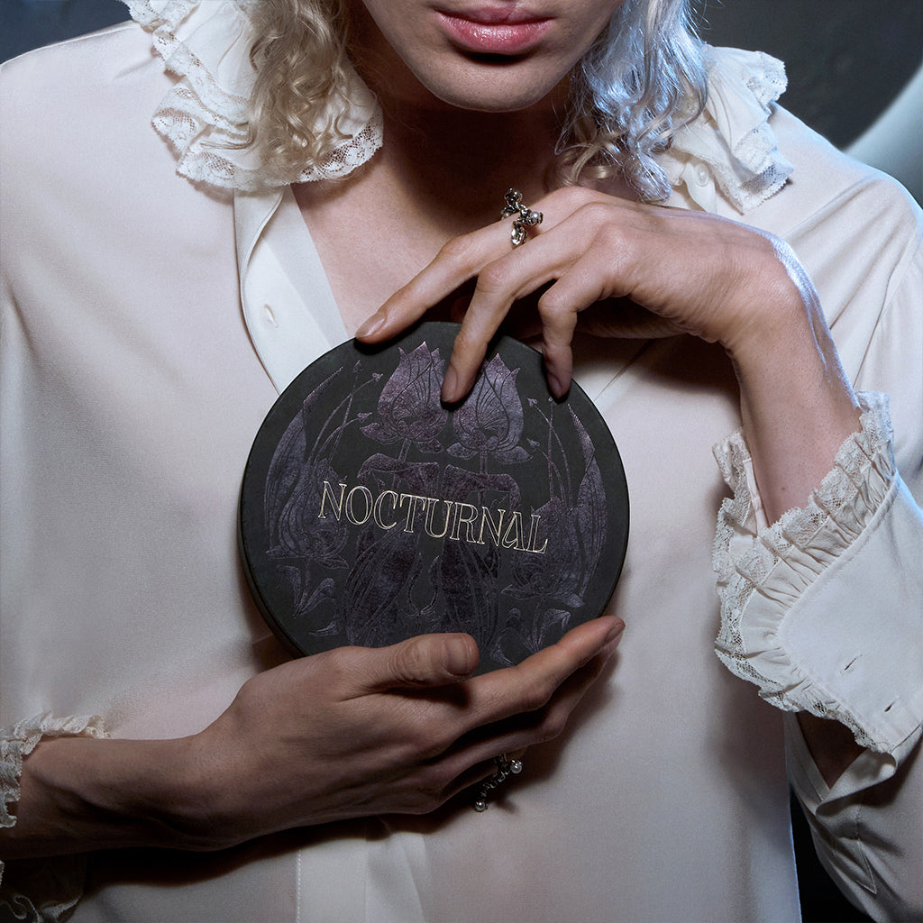 Hands holding Nocturnal round box
