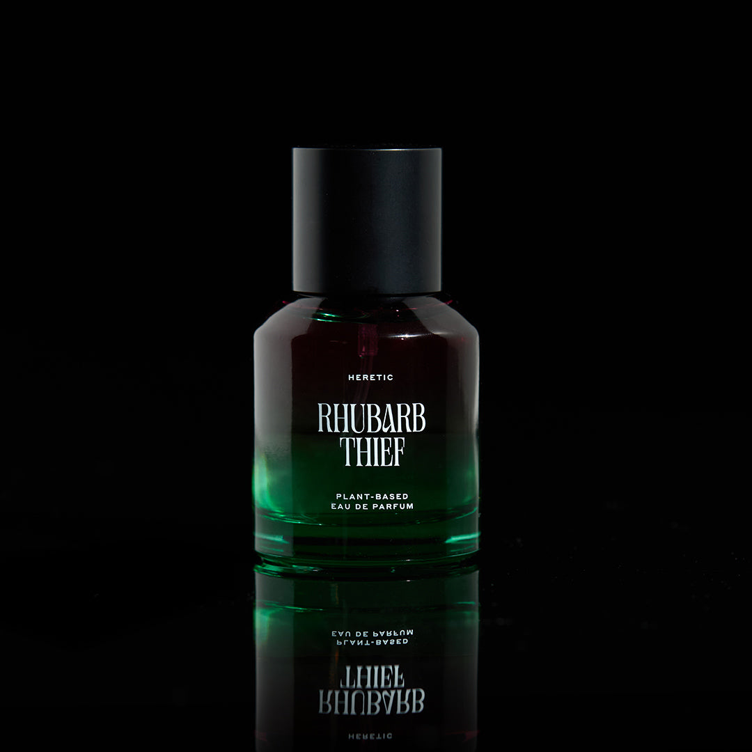 Perfume bottle labeled 'Rhubarb Thief' by Heretic on a black background