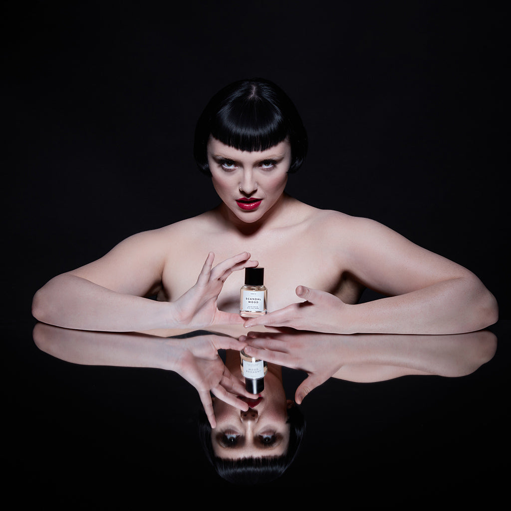 Model holding Scandalwood perfume